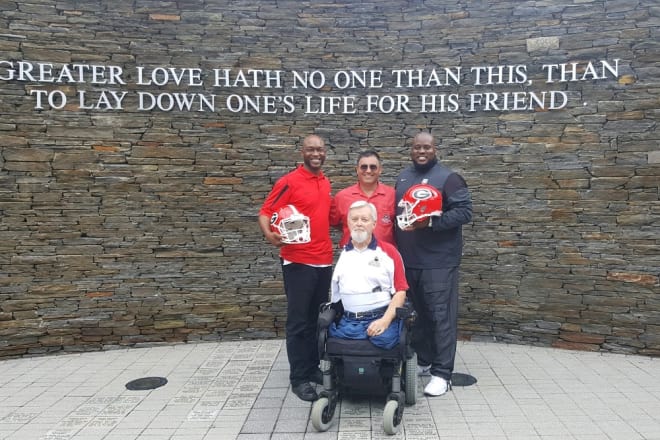 Rodgers and Tommy Clack pose with former Georgia standouts Corey Allen (left) and Travis Stroud (right) at the Walk of Heroes Veteran War Memorial.
