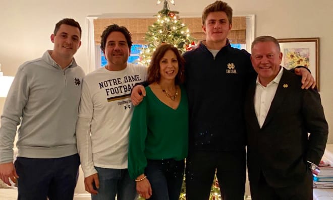 Kevin Bauman (second from right) with family, offensive coordinator Tommy Rees and Brian Kelly.