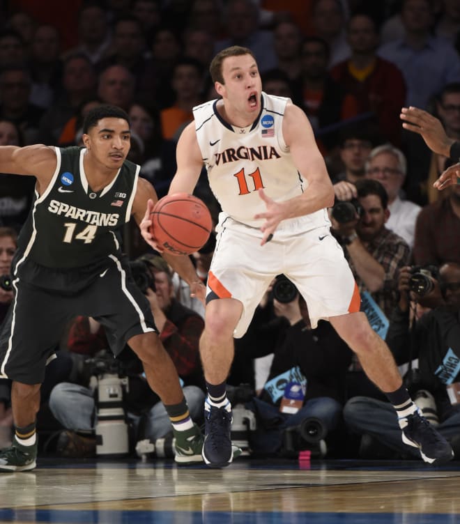Virginia Cavaliers forward Evan Nolte (11) picks up a loose ball against Michigan State Spartans guard Gary Harris (14) during the first half in the semifinals of the east regional of the 2014 NCAA Mens Basketball Championship tournament at Madison Square Garden.