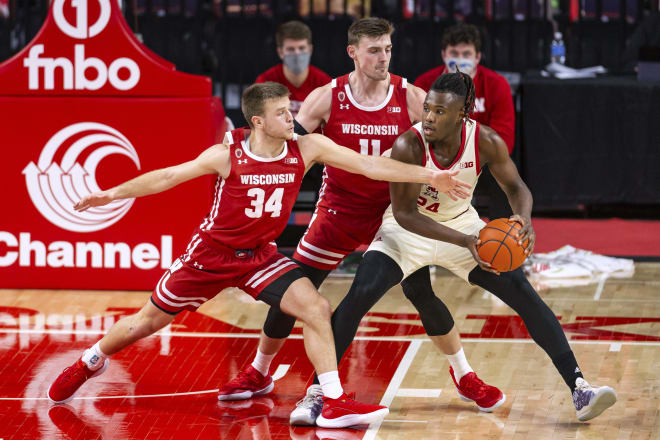 Wisconsin guard Brad Davison (34) reaches for the ball held by Nebraska forward Yvan Ouedraogo (24) during UW's 61-48 win.