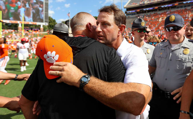 Clemson head coach Dabo Swinney and N.C. State head coach Dave Doeren meet at midfield in Death Valley on Saturday following the Tigers' 59-35 win over The Wolfpack.