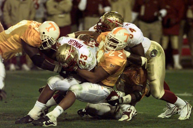 Tennessee's Corey Terry (22) and Eric Westmoreland (42, under pile) take down Florida State's Travis Minor (23) in the fourth quarter of the Fiesta Bowl national championship game Jan. 4, 1999