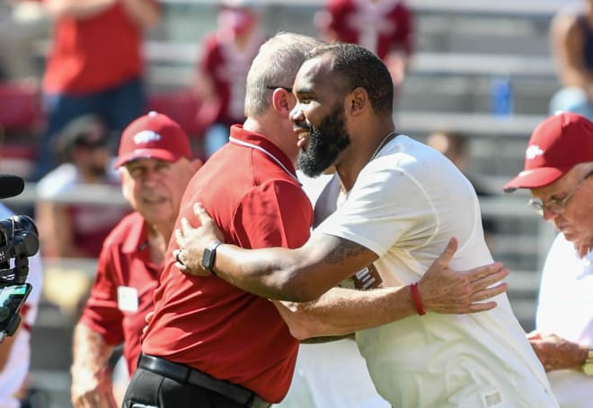 Former Arkansas running back Darren McFadden (right) hugs Razorbacks Athletics Director Hunter Yurachek during the Georgia Southern game on Sept. 18, 2021.