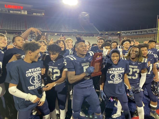 Raphael Tucker (#5) holds the Class 4 trophy Saturday evening at Liberty University. 