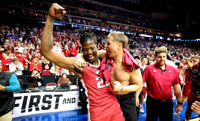 Arkansas head coach Eric Musselman (right) celebrates with forward Makhel Mitchell (left) after the NCAA Tournament win over Kansas in March.