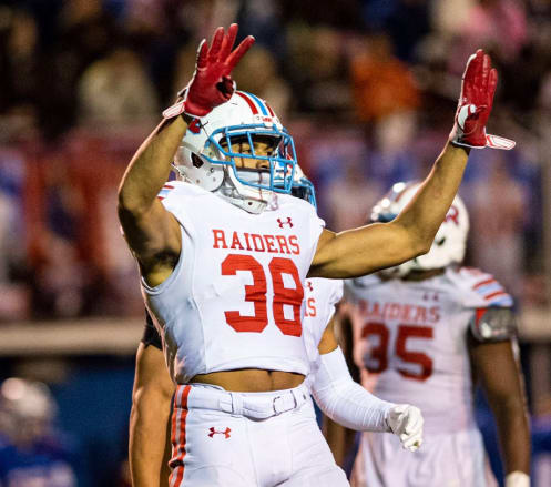 Rummel LB Kolbe Fields communicates with coaches on the sideline between downs during a district football game against John Curtis Christian (LA.) during the 2019 season.