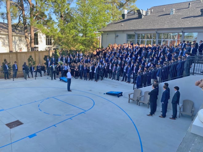 Cal Mayo speaks to those gathered at the Sigma Chi fraternity house. 