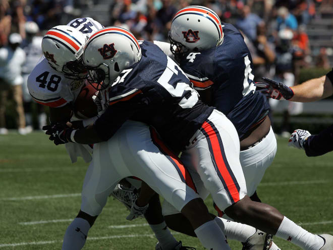 Davis and Buck Jeff Holland team up on a tackle in the A-Day game.