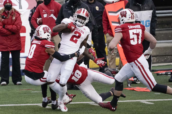 Safeties Eric Burrell (8) and Collin Wilder (18) take down Indiana wide receiver Jacolby Hewitt with LB Jack Sanborn in pursuit.