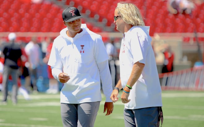 WR coach Joel Filani and offensive coordinator David Yost talk during pregame practice on the field at Jones AT&T Stadium. Texas Tech went on to defeat Montana State, 45-10, in the season opener on Aug. 31, 2019.