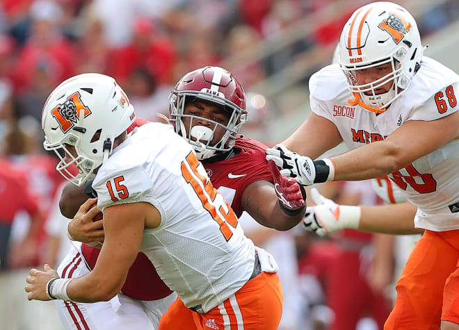 Alabama defensive lineman D.J. Dale records a sack on Mercer quarterback Carter Peevy. Photo | Getty Images