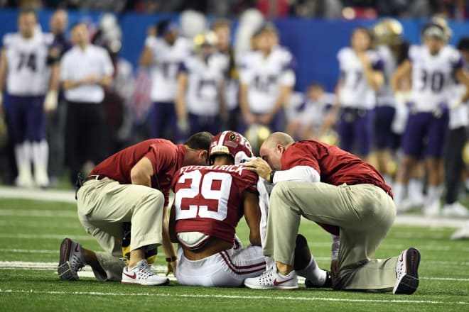 Trainers tend to Alabama defensive back Minkah Fitzpatrick during the Peach Bowl last season. Photo | USA Today