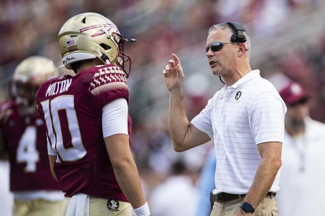 FSU coach Mike Norvell speaks with McKenzie Milton during the Louisville game.
