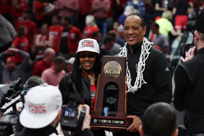 Mar 31, 2024; Dallas, TX, USA; North Carolina State Wolfpack head coach Kevin Keatts and his wife Georgette Keatts celebrate with the trophy after defeating the Duke Blue Devils in the finals of the South Regional of the 2024 NCAA Tournament at American Airline Center. Mandatory Credit: Tim Heitman-USA TODAY Sports
