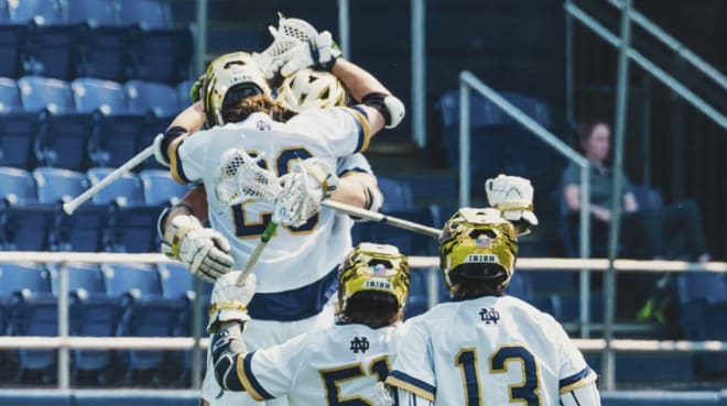 Notre Dame players celebrate a 12-9 NCAA Tournament quarterfinal victory over Johns Hopkins, Sunday at Annapolis, Md.