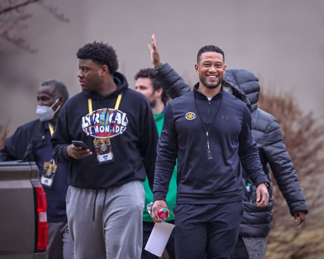 Five-star defensive tackle Justin Scott (left) and Notre Dame head coach Marcus Freeman on their way to a recent Irish spring practice.