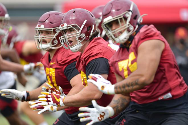 From left, Justin Dedich, Andrew Vorhees and Alijah Vera-Tucker going through drills Saturday.