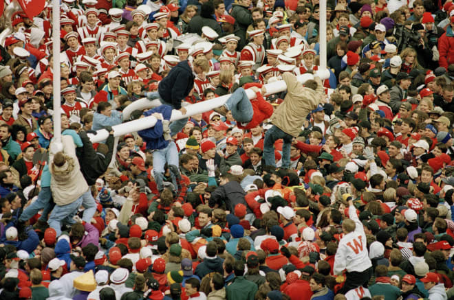 Wisconsin fans swarm onto a goalpost on the filed at Camp Randall Stadium in Madison, Wis., Oct. 30, 1993 following Wisconsin's 13-10 win over Michigan. Police report at least 30 people were injured as fans poured onto the field after the game.