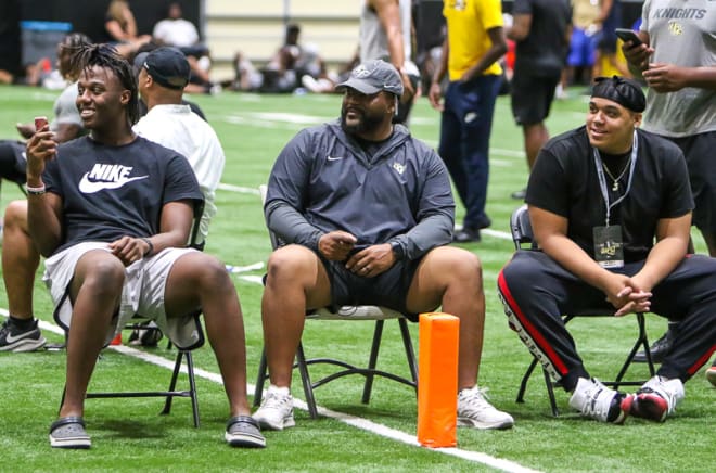 Derrick LeBlanc (left) and John Walker (right) with defensive tackles coach Kenny Martin during UCF's Prospect Camp.