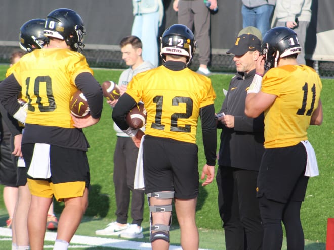 Tim Lester and Iowa's quarterbacks gather at spring practice. 