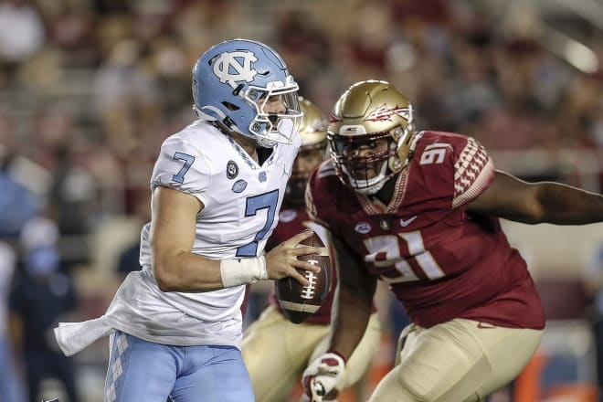 Defensive lineman Robert Cooper chases UNC quarterback Sam Howell.