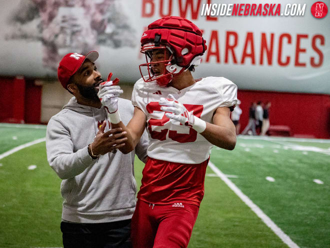 Nebraska football secondary coach Evan Cooper loves what first-year transfer Blye Hill (right) brings to the table for the Huskers