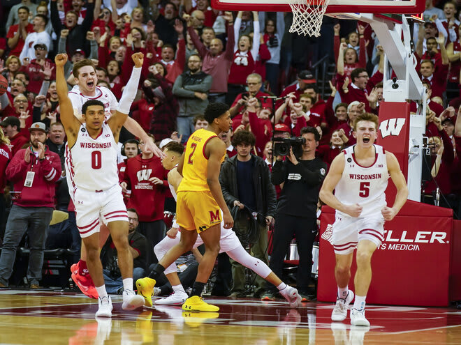 Wisconsin's D'Mitrik Trice (0), Nate Reuvers, behind, and Tyler Wahl (5) celebrate as Maryland's Aaron Wiggins (2) walks off the court following UW's  56-54 win in 2020.