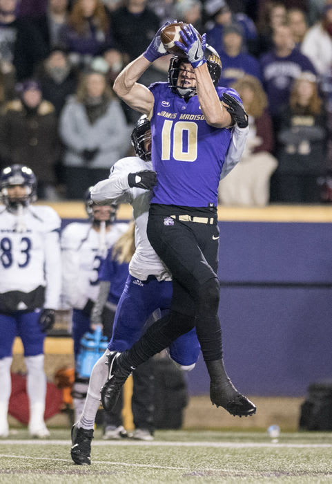 James Madison wide receiver Riley Stapleton (10) reaches up for a long catch against Weber State