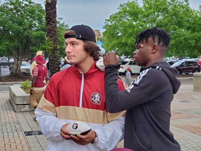 FSU commits Nicco Marchiol and Travis Hunter sign autographs for fans after the spring game.