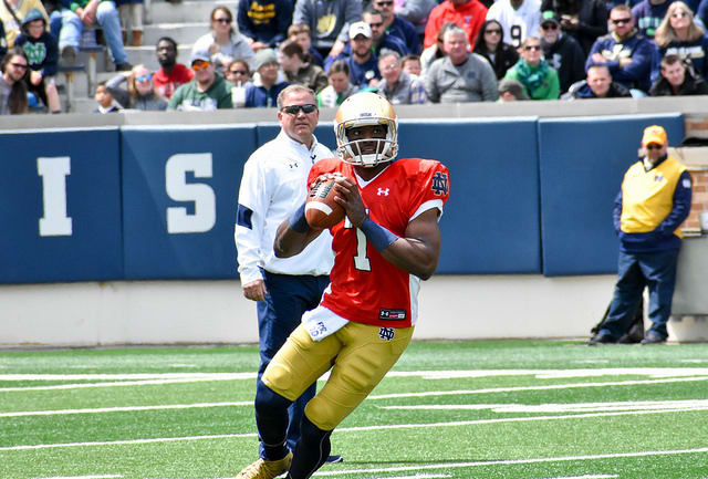 No. 7 Brandon Wimbush is projected as the seventh different opening game starter at QB in as many years under Brian Kelly (in the background).