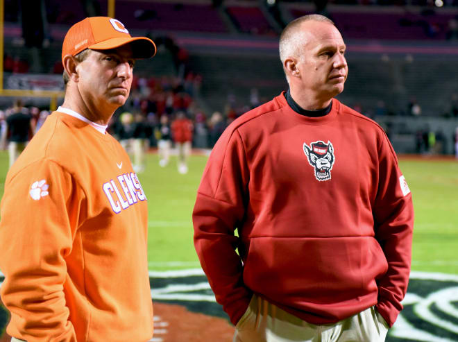Head coach Dabo Swinney (left) and the Tigers clinched the ACC Atlantic Division title with their 55-10 victory over head coach Dave Doeren (right) and the Wolfpack on Saturday.