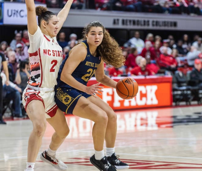 Notre Dame's Maddy Westbeld (21) tries to drive on NC State's Mimi Collins.