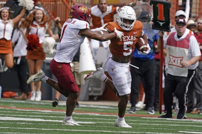 Anthony Johnson tries to bring down Bijan Robinson, who rolled for 135 yards on 28 carries in Texas' win.