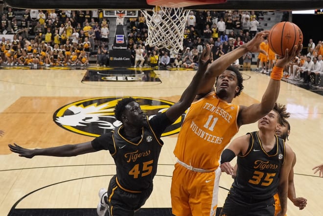 Tennessee forward Tobe Awaka (11) shoots under pressure from Missouri center Mabor Majak (45) during the first half of an NCAA college basketball game Tuesday, Feb. 20, 2024, in Columbia, Mo. (AP Photo/Charlie Riedel)
