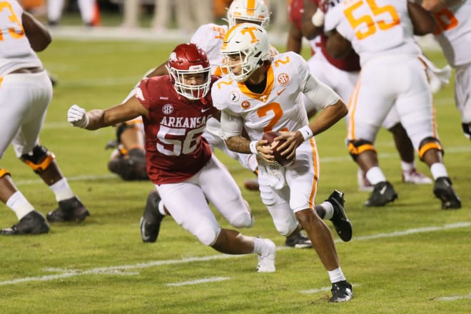 Arkansas defensive end Zach Williams chases Tennessee quarterback Jarrett Guarantano during last week's game.