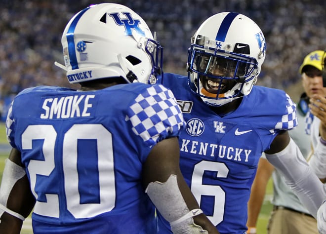 Josh Ali celebrates Kavosiey Smoke's first-quarter TD run against Eastern Michigan. 