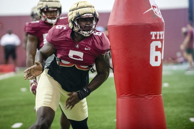 Dennis Briggs does a pass rush drill in Monday's practice.