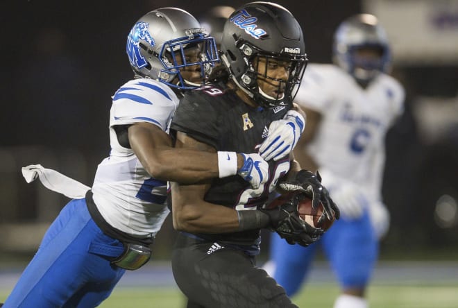 Memphis defensive back Tito Windham tries to bring down Tulsa wide receiver Justin Hobbs.