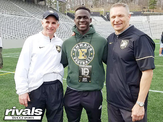 2019 RB Sone Nthoh surrounding by Army safety coach John Loose and head coach Jeff Monken