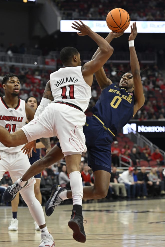 Notre Dame guard Blake Wesley (0) shoots against Louisville's Mason Faulkner (11) Saturday during the first half at KFC Yum! Center in Louisville, Ky.