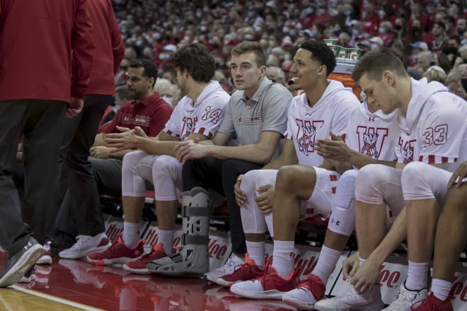 Forward Tyler Wahl sits with a protective boot on his right ankle during UW's game against Michigan State. It was the first collegiate game Wahl has missed in three seasons.