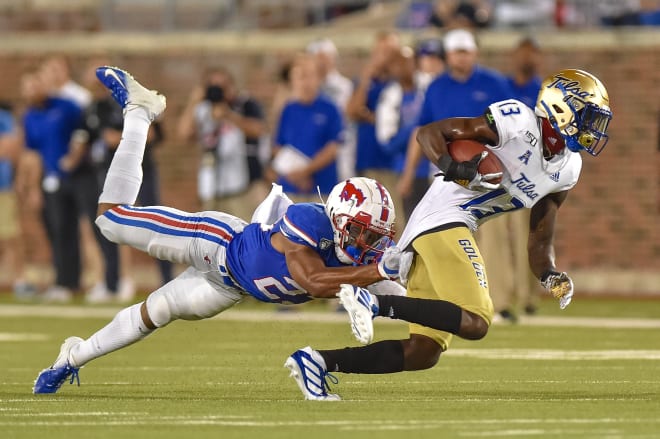 Tulsa WR Josh Johnson tries to slip out of the grasp of an SMU defender in 2019's match-up, in which TU lost in triple overtime.