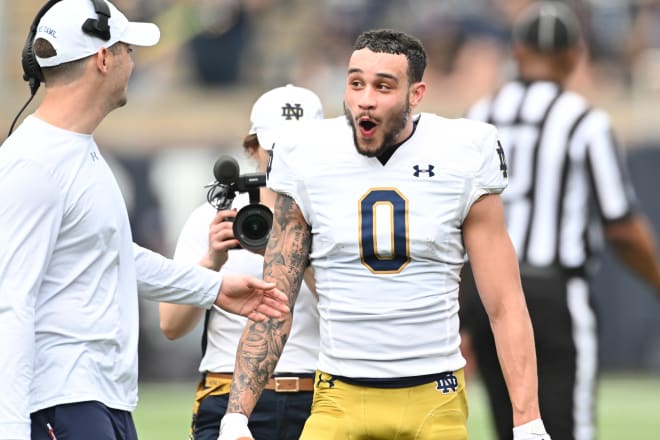 Notre Dame wide receiver Btaden Lenzy (0) chats with offensive coordinator Tommy Rees during the Blue-Gold Game on April 23.