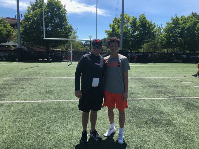 Williams snaps a picture with Jonathan Smith during an OSU football camp in 2019