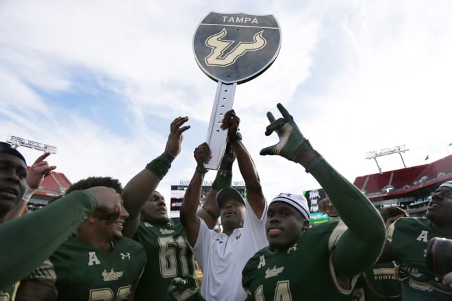 Willie Taggart and USF players celebrate the rivalry win over UCF on Nov. 26 in Tampa.