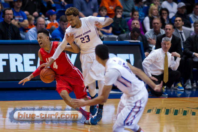 Boise State' Jame Webb III (23) fouls New Mexico's Elijah Brown (4) while trying to steal the ball.