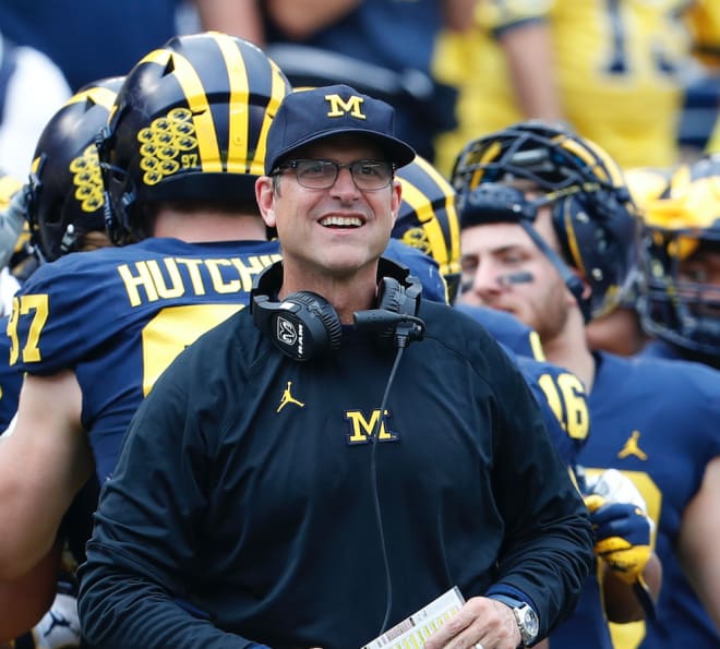 Michigan Wolverines football coach Jim Harbaugh smiling.