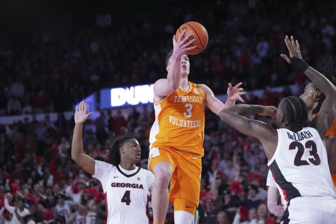 Tennessee guard Dalton Knecht (3) goes in for a shot as Georgia's Silas Demary Jr. (4) and Jalen DeLoach (23) defend during the second half of an NCAA college basketball game Saturday, Jan. 13, 2024, in Athens, Ga. (AP Photo/John Bazemore)