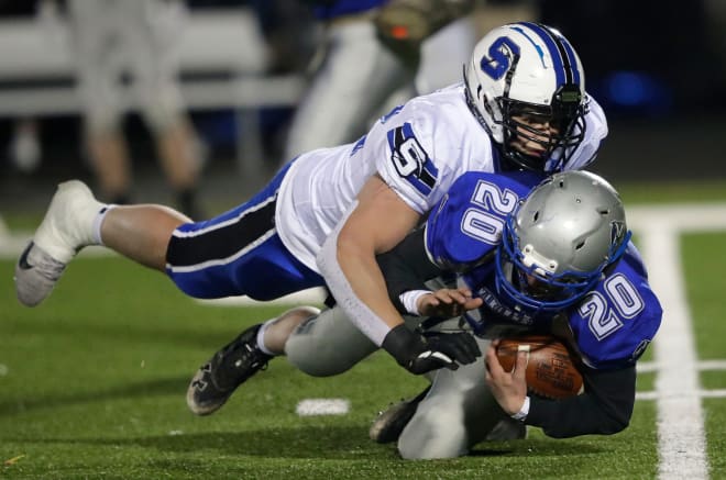 St. Mary's Springs Academy's Billy Schrauth (72) tackles Winnebago Lutheran Academy's Jack Karst (20) for a loss during their football game at Ingalls Field Wednesday, March 31, 2021, in Ripon, Wis.