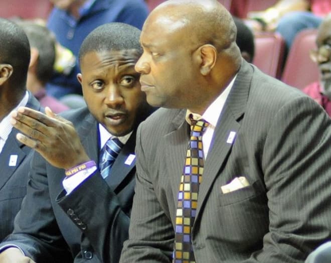Assistant coach Dennis Gates offers input during a game to FSU head coach Leonard Hamilton.